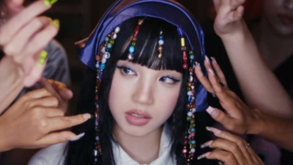 i-dle's Woogie reveals 90s-inspired music video for her single 'Motivation,' featuring bold visuals and a unique hip-hop style.