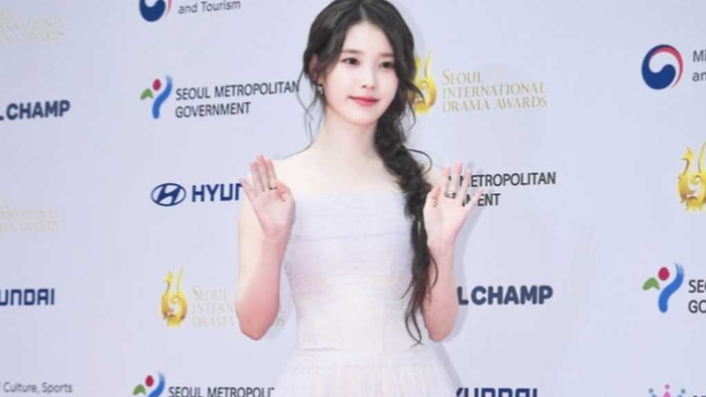 IU surprises staff with gifts, including gold and vouchers, during Chuseok, highlighting her generosity and upcoming drama.
