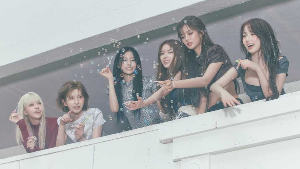 NMIXX unveils concept photos for their 1st album 'Blue Valentine', showcasing contrasting themes of joy and loneliness ahead of their release.