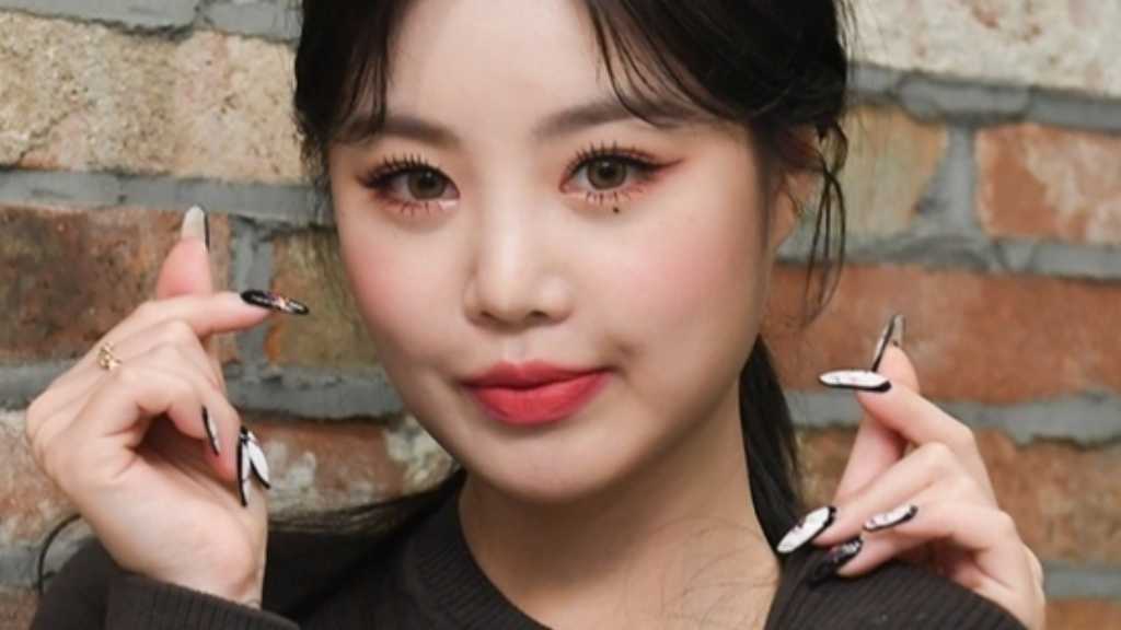 Soojin announces her new single "BADITUDE" releasing on August 27, exciting fans with a teaser image and hints of vibrant music.