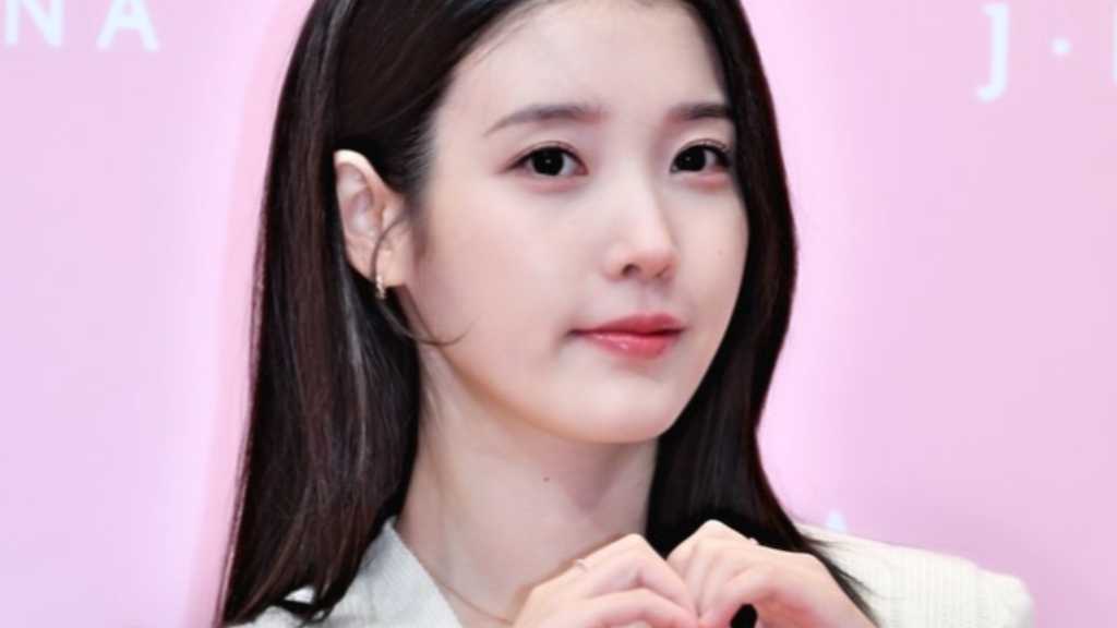 IU attended the J.ESTINA pop-up store opening at Lotte Department Store in Seoul, showcasing a new campaign and upcoming events.