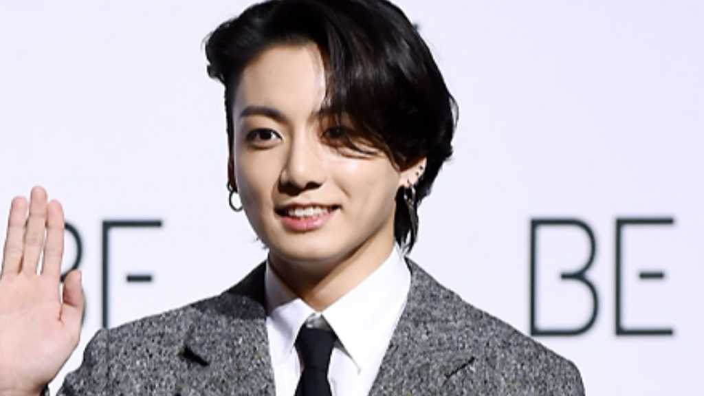 BTS's Jungkook shares he lives with a childhood friend during a cooking live stream, discussing their playful relationship.