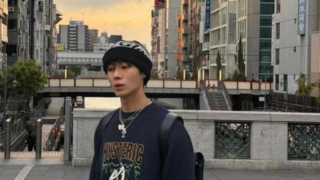 Choo Young-woo posts vacation photos from Japan, showcasing his model-like visuals and humor, while preparing for his film debut.