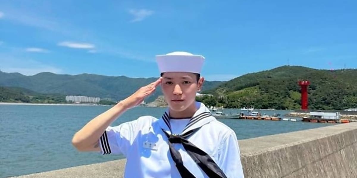 NCT's Taeyong shares navy enlistment graduation news on official SNS with photos, saluting in sailor suit by the sea.
