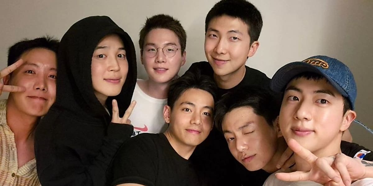 BTS members gather for special photo to celebrate Jin's completion of military service, delighting fans with their bond and visuals.