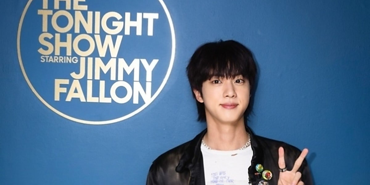 BTS's Jin captivates fans on The Tonight Show, performing 'Running Wild' and sharing insights about his new album 'Happy'.