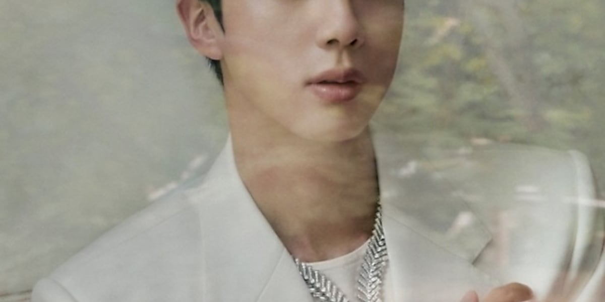 BTS's Jin showcases stunning visuals in three Vogue Korea covers, wearing a white suit and a wine-colored knit with black pants.