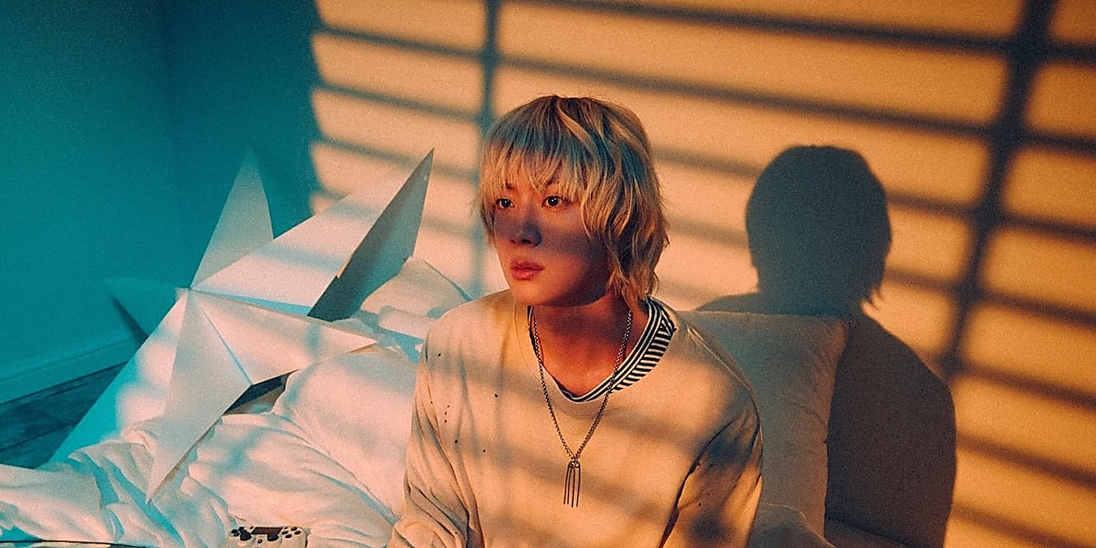 BTS's Jin's solo album 'Happy' sells over 845,000 copies on its first day, surpassing his previous record and topping charts worldwide.