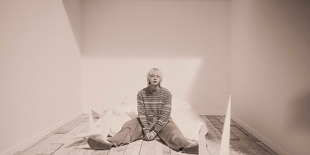 Jin's solo album 'Happy' debuted at No. 1 on Oricon. He expresses love and positivity through his music, featuring 6 tracks.