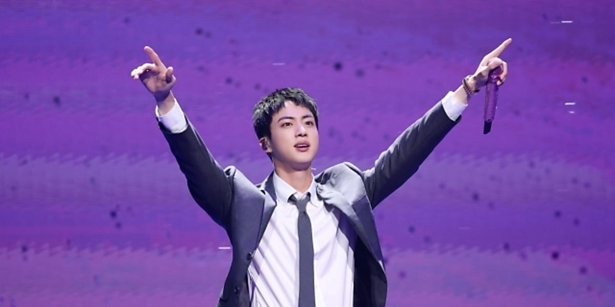 Jin reunites with fans at special event post-discharge, marking BTS anniversary. Fans enjoy special time with Jin.